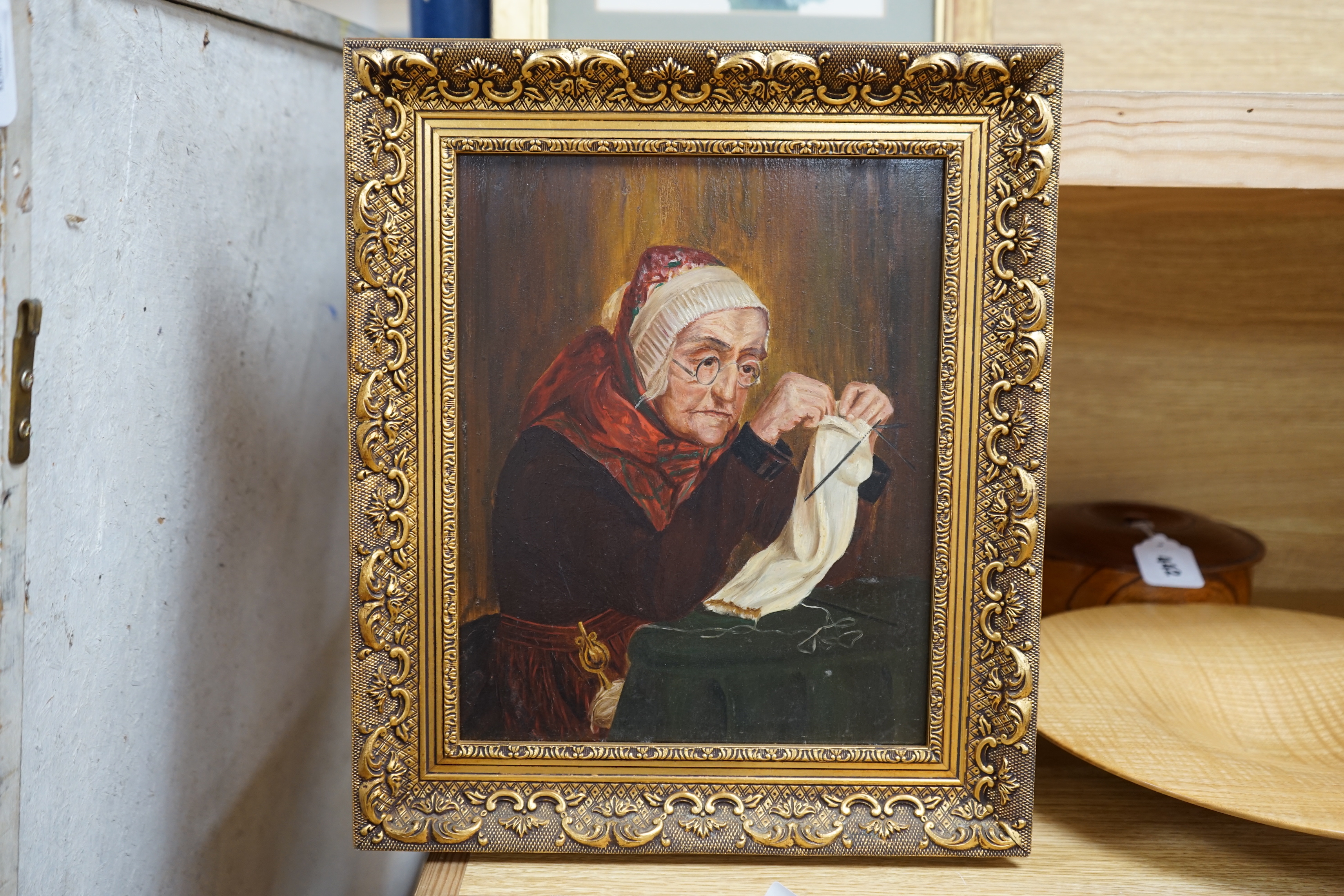 Early 20th century, oil on board, Portrait of an elderly lady sewing, 28 x 21cm, ornate gilt framed